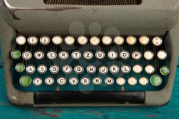 Vintage typewriter on the blue wooden desk 