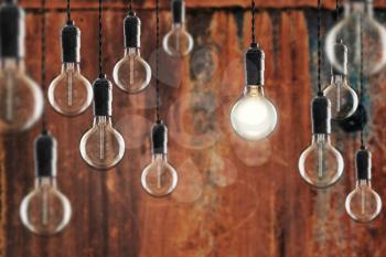 Idea and leadership concept Vintage incandescent Edison type bulbs on color wall