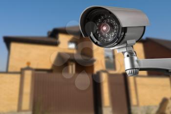 Security camera and private house on the background