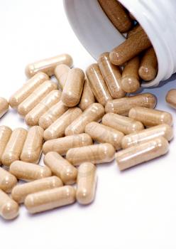 Closeup image of brown pills - roughage on the white background.