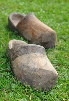 Two old Dutch clogs on the grass.