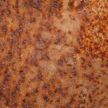 Closeup shot of old orange rust on the metal surface.