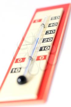 Old vintage red thermometer on a white background.