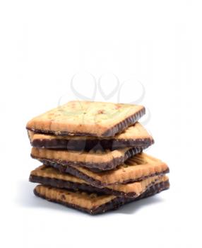 Stack of butter cookies with dark chocolate topping on a white background.