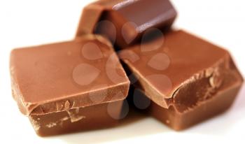 Macro shot of chocolate pieces on white background.