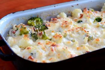 Cauliflower and broccoli with grated parmesan baked in black pan.