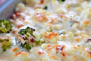 Closeup of baked cauliflower and broccoli with grated parmesan.