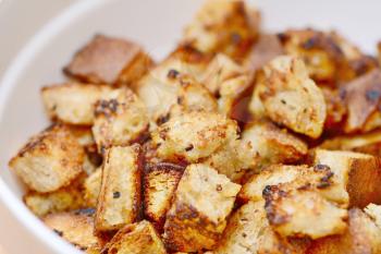 Closeup of Bread Croutons in White Bowl.