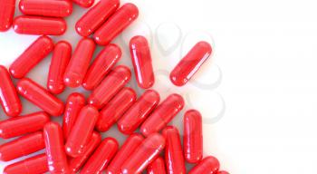 Red capsules on the white background top view.