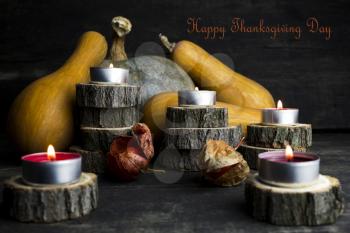 Happy Thanksgiving Day, Decoration on a wooden table with Burning Candles and  Pumpkins, Corncob, autumn leaves in the background