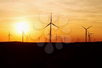 Wind Turbines Over Sunset Sky Generating Electricity. Sustainable Energy Power Generators, Renewable Power Supply