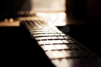 Acoustic Guitar In Music Studio Close up. Shined By The Sun At The Golden Hour 