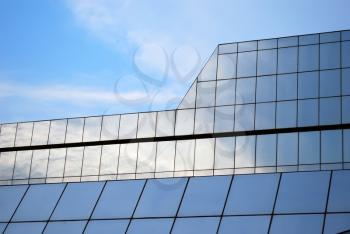 Building glass wall with sky reflection