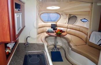 Luxury yacht cabin interior with fruits and champagne