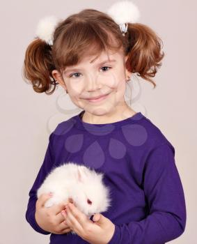 little girl holding cute dwarf bunny