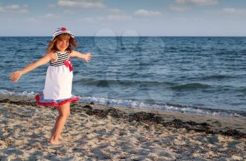 beautiful happy little girl on beach