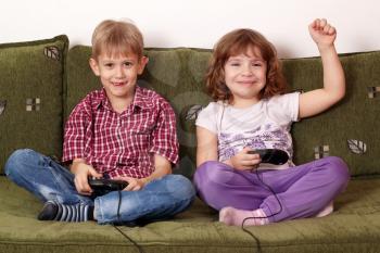 little girl and boy play video game