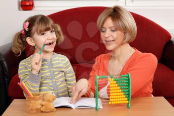 Mom helps daughter to solve homework