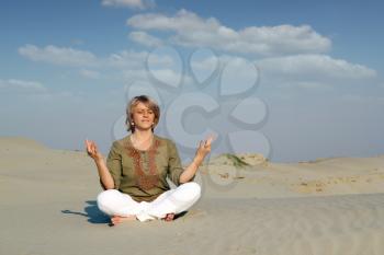 beautiful woman meditating in desert healthy lifestyle