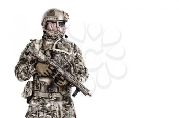 Half length low angle studio shot of special forces soldier in field uniforms with weapons, portrait isolated on white background lot of copyspace. Protective goggles glasses are on