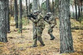 Pair of norwegian Rapid reaction special forces FSK soldiers in field uniforms in action in the forest