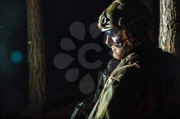 Image of soldier in the forest. Back light, cropped, toned and colorized