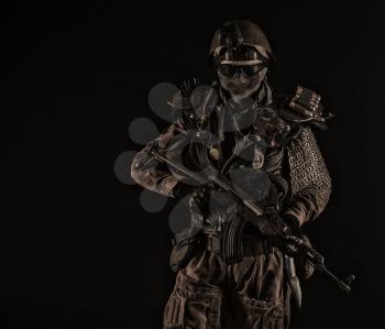 Nuclear post apocalypse life after doomsday concept. Grimy survivor with homemade weapons. Studio portrait