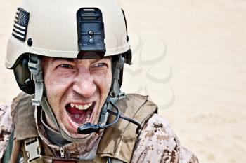 Scary face of US marine in the marpat uniform showing teeth