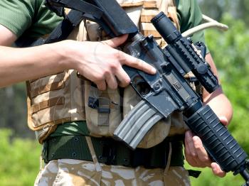 British Royal Commando in camouflage uniform holding his rifle