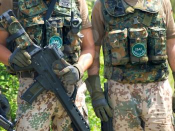 Bundeswehr soldiers in camouflage uniform holding their .rifles