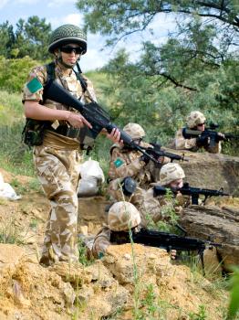 British soldiers in desert uniform in action