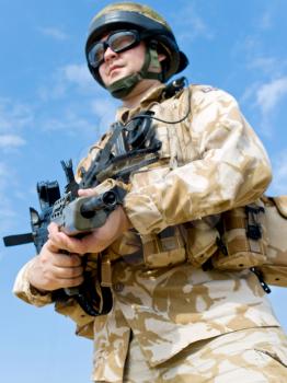 British Royal Commando in desert uniform holding his rifle