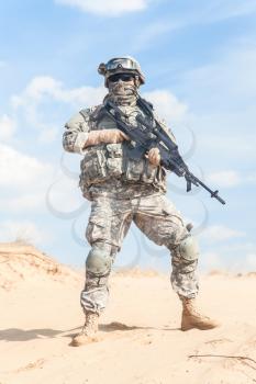 Portrait of United states airborne infantry marksman with arms, camo uniforms dress. Combat helmet on, face mask, full body