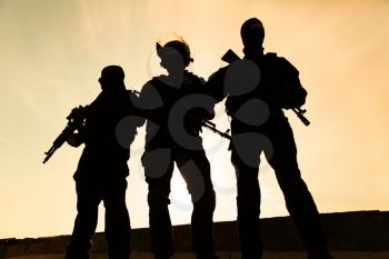 Silhouette of special forces operators with weapons