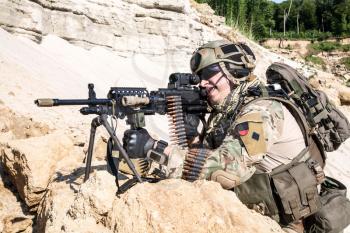 United States Army ranger in the mountains with machine gun