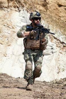 Member of Navy SEAL Team with weapons in action 