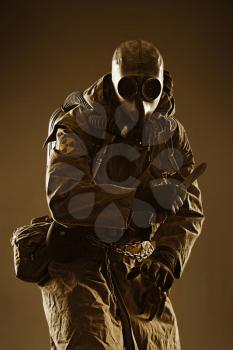 Nuclear post apocalypse. Studio shot of survivor in tatters and gas mask