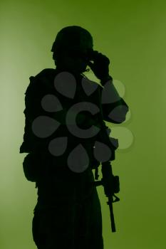 United states Marine Corps special operations command Marsoc raider with weapon. Silhouette of of Marine Special Operator green background