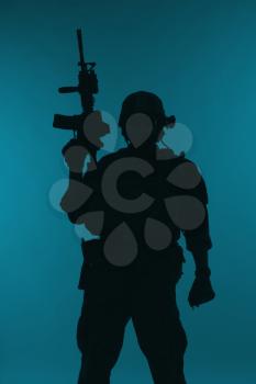 United states Marine Corps special operations command Marsoc raider with weapon. Silhouette of of Marine Special Operator blue background