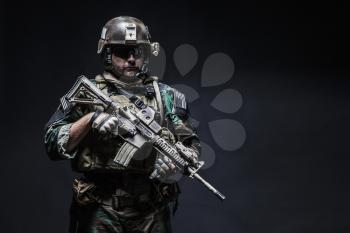 United states Marine Corps special operations command Marsoc raider with weapon. Studio shot of Marine Special Operator black background