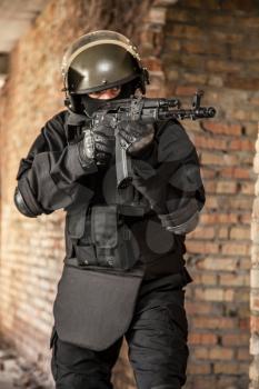 Special forces operator in black uniform and bulletproof 