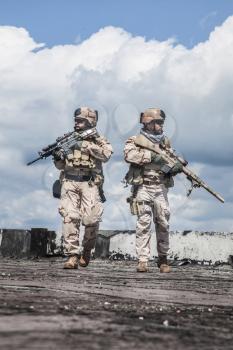 Navy SEALs Team with weapons in action 