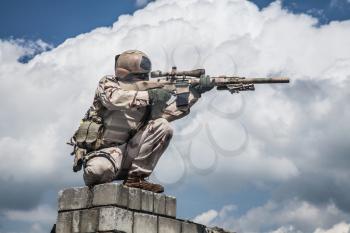 Member of Navy SEAL Team with weapons in action 