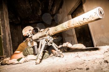 Navy Seal Sniper with rifle in action 