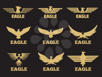 Gold heraldic eagles logo collection on black background. Vector eagle emblem silhouette, bird element icon of set illustration