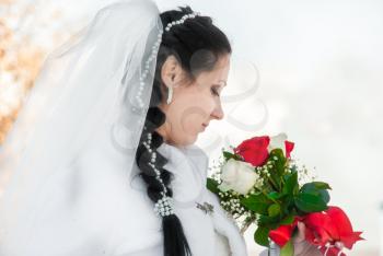 Portrait of the bride with a bunch of flowers, in a wedding dress