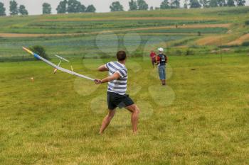 Lviv, Ukraine - July 23, 2017: Unknown aircraft modelers  launches his own radio-controlled  model  glider  in the countryside near the city of Lviv., Ukraine.