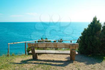 Wooden bench beautiful view on the sea. Green environment landscape
