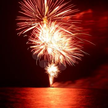 Red colorful holiday fireworks on the black sky background.