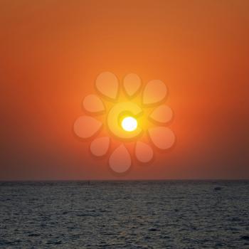 Beautiful orange sunset on the sea with shining sun